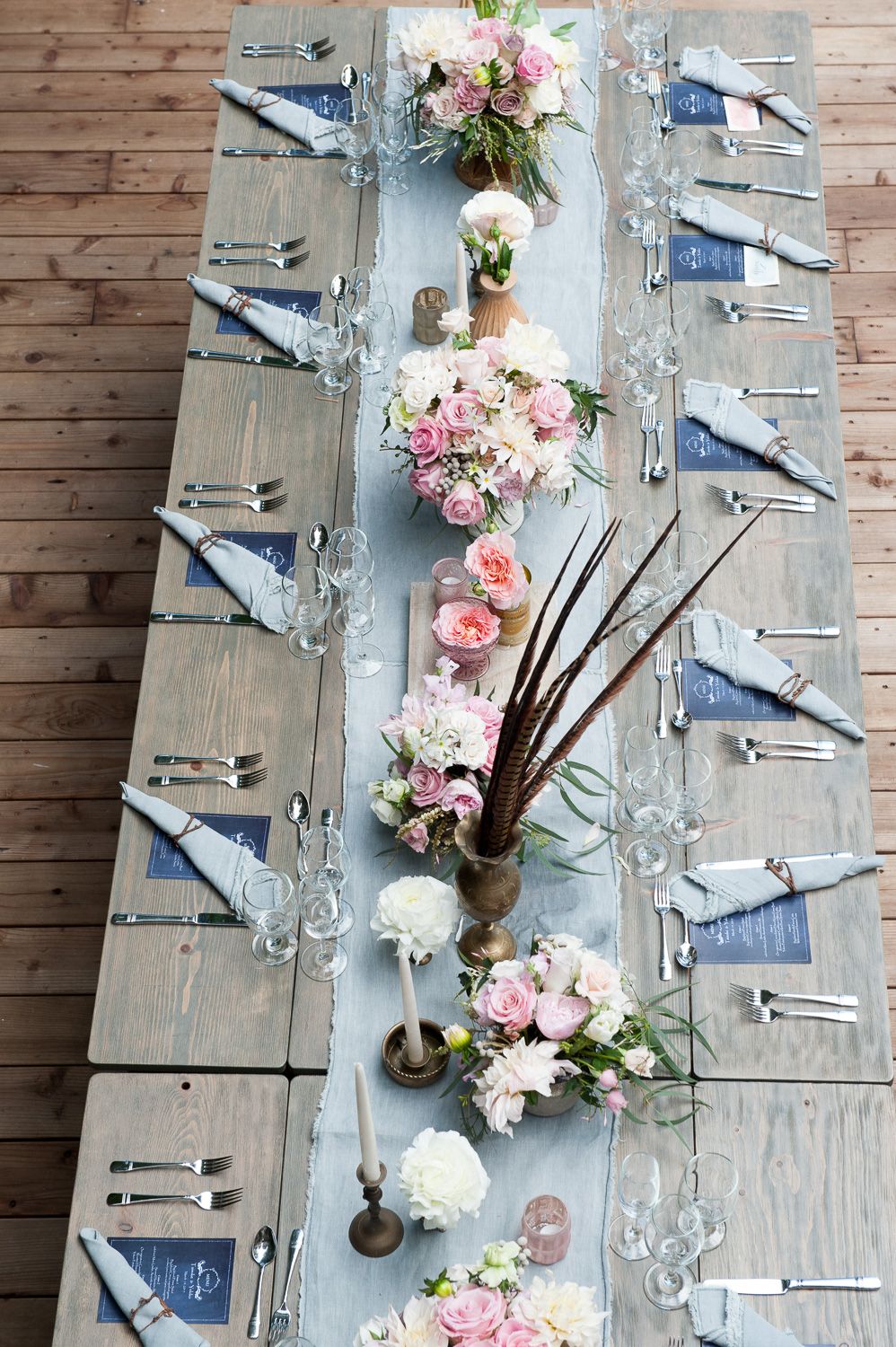 Looking at a table from above. Blue napkins and menus