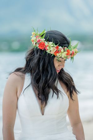 Bride with haku lei looking downwards