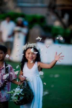 Flower girl throwing flowers down the aisle