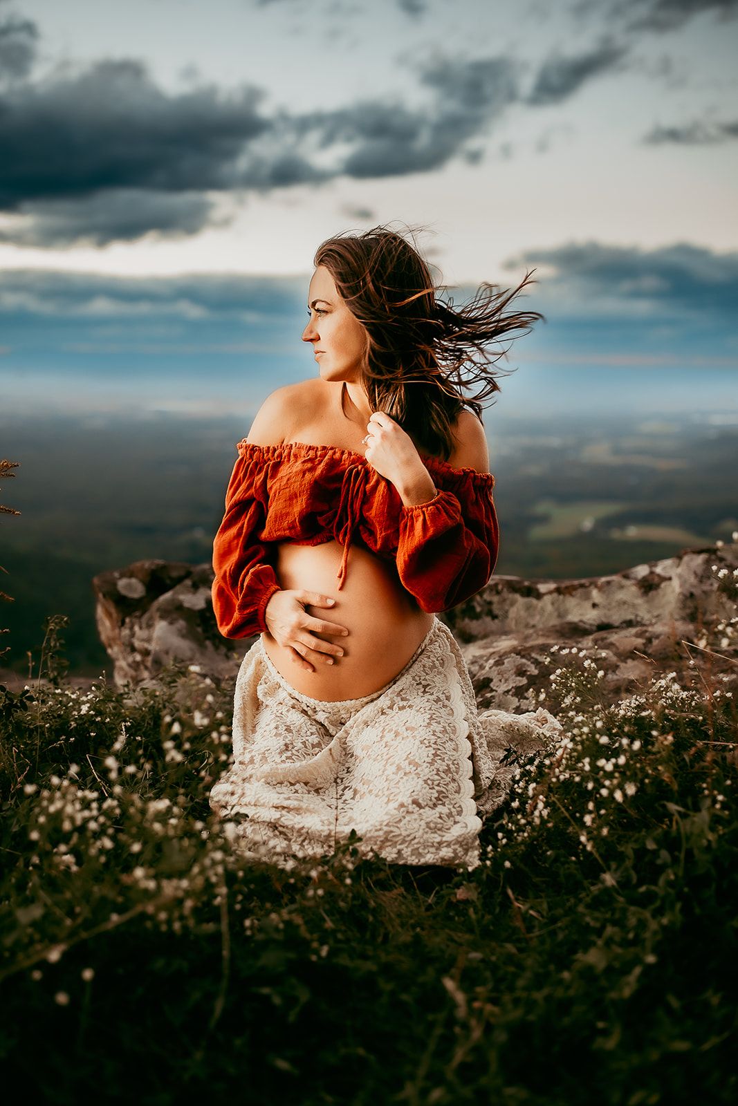 An expectant mother watches the sunset at Raven's Roost Overlook.