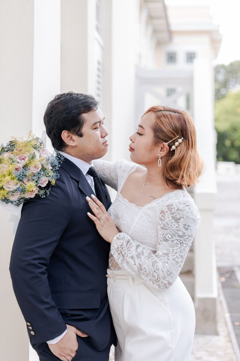 Wedding couple posing at Fort Canning after their ROM solemnisation at the Registry of Singapore.