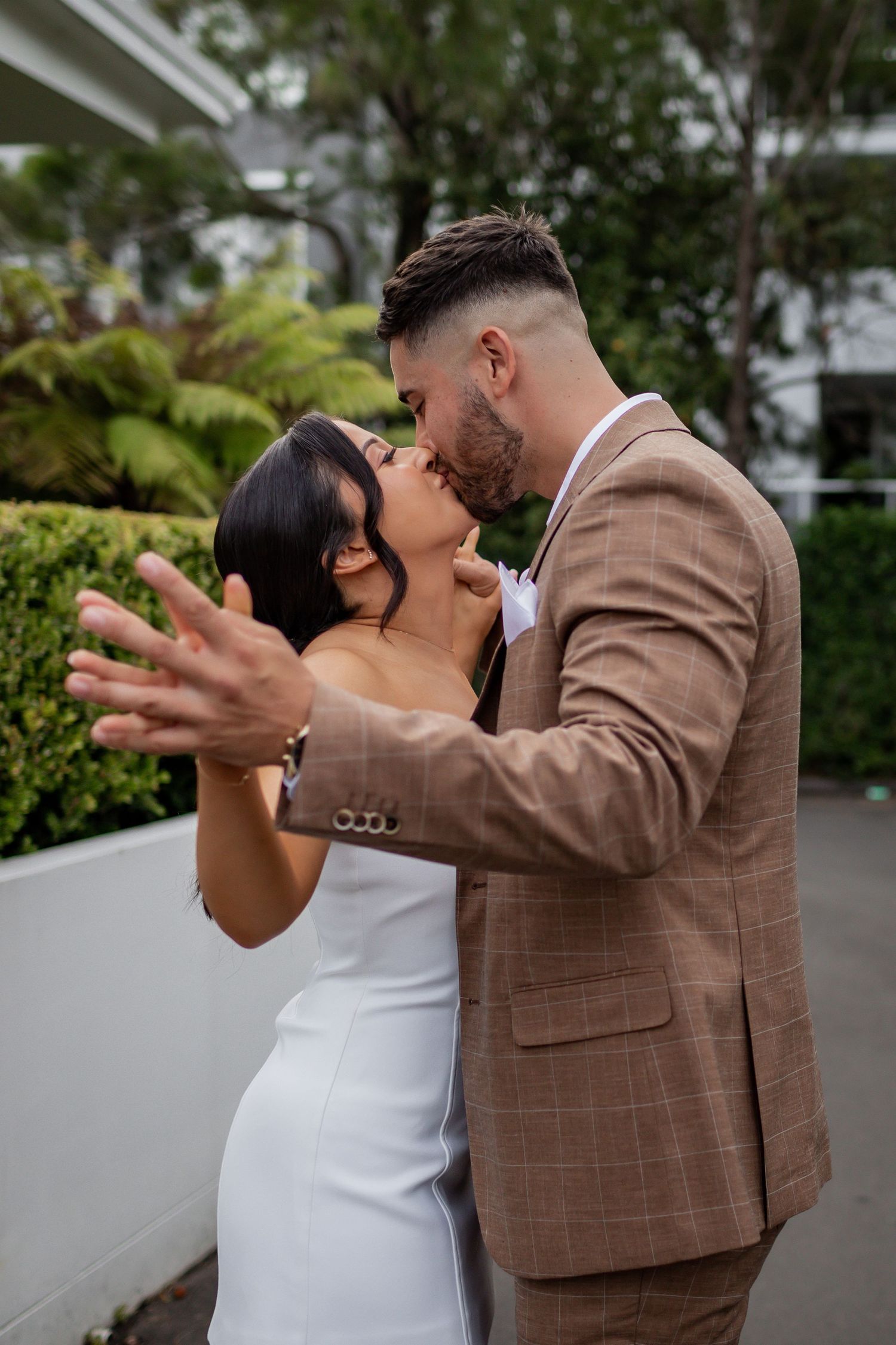 Romantic couple embracing in an intimate moment outdoors.