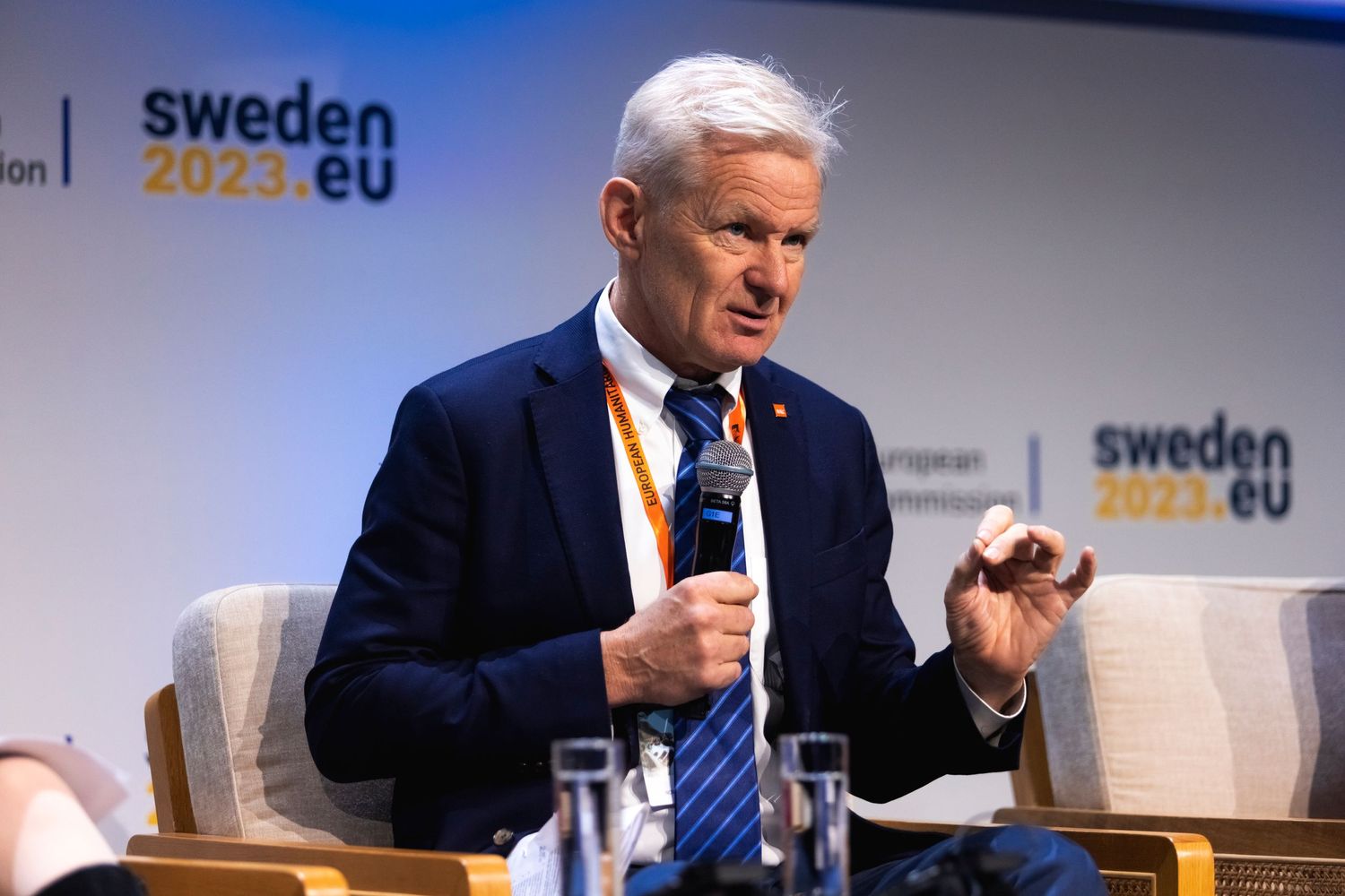 Speaker at Sweden 2022 EU conference gestures while addressing audience.
