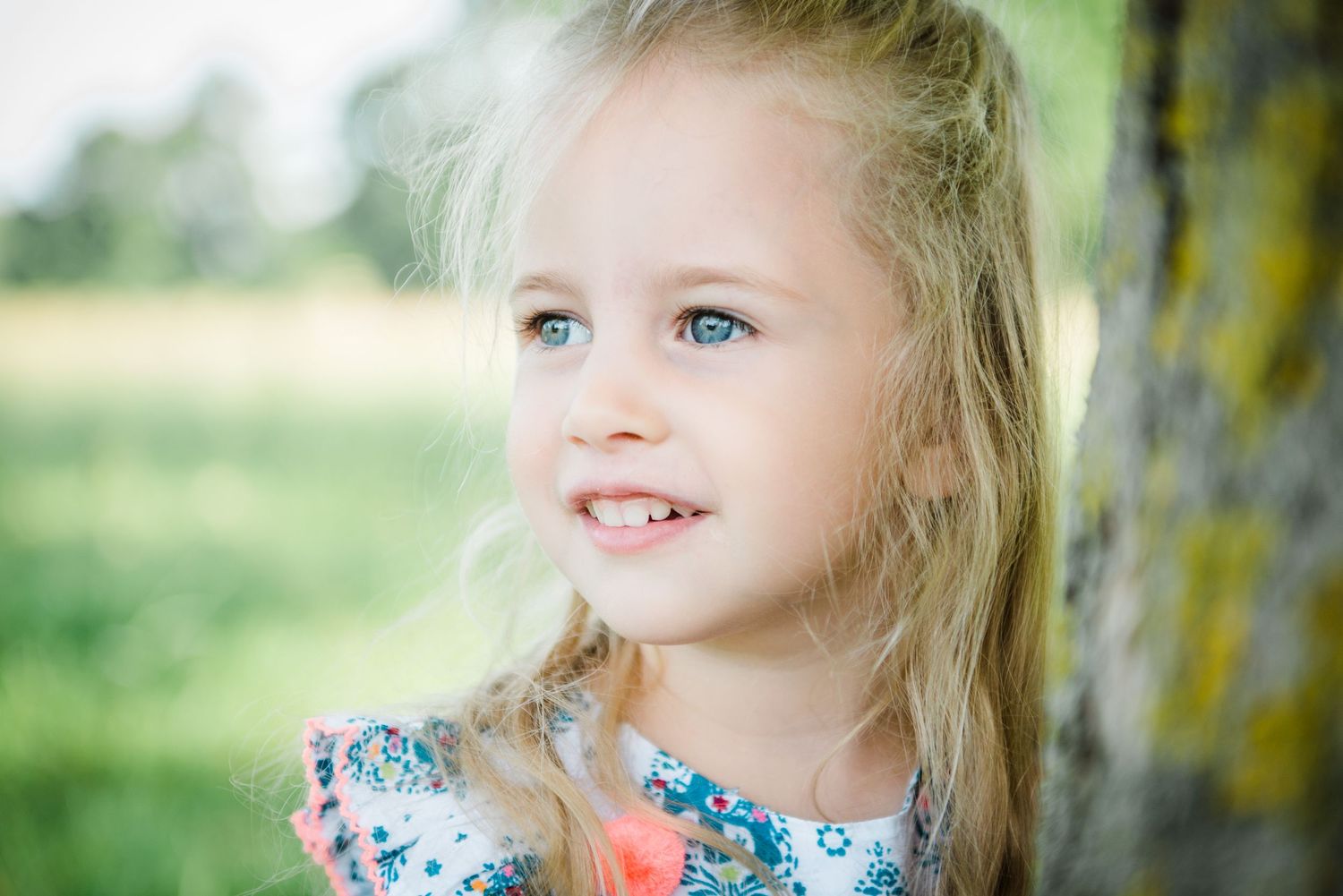 portrait of a little girl with blue eyes gazing into the distance