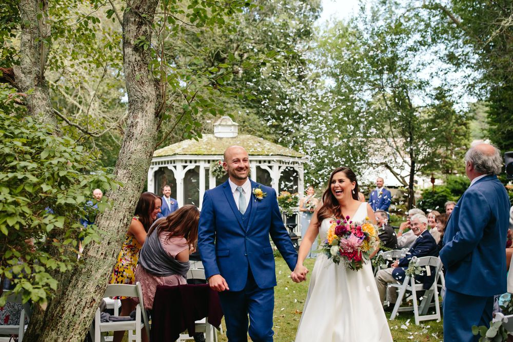 Bride and groom walk up the aisle in a backyard garden wedding ceremony in Massachusetts
