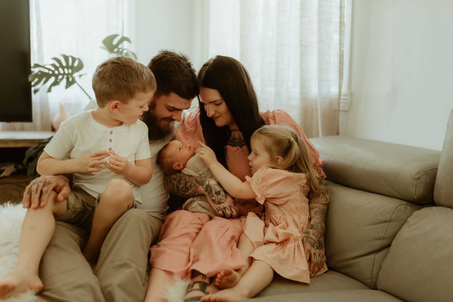 A family shares an intimate moment together on their living room couch.