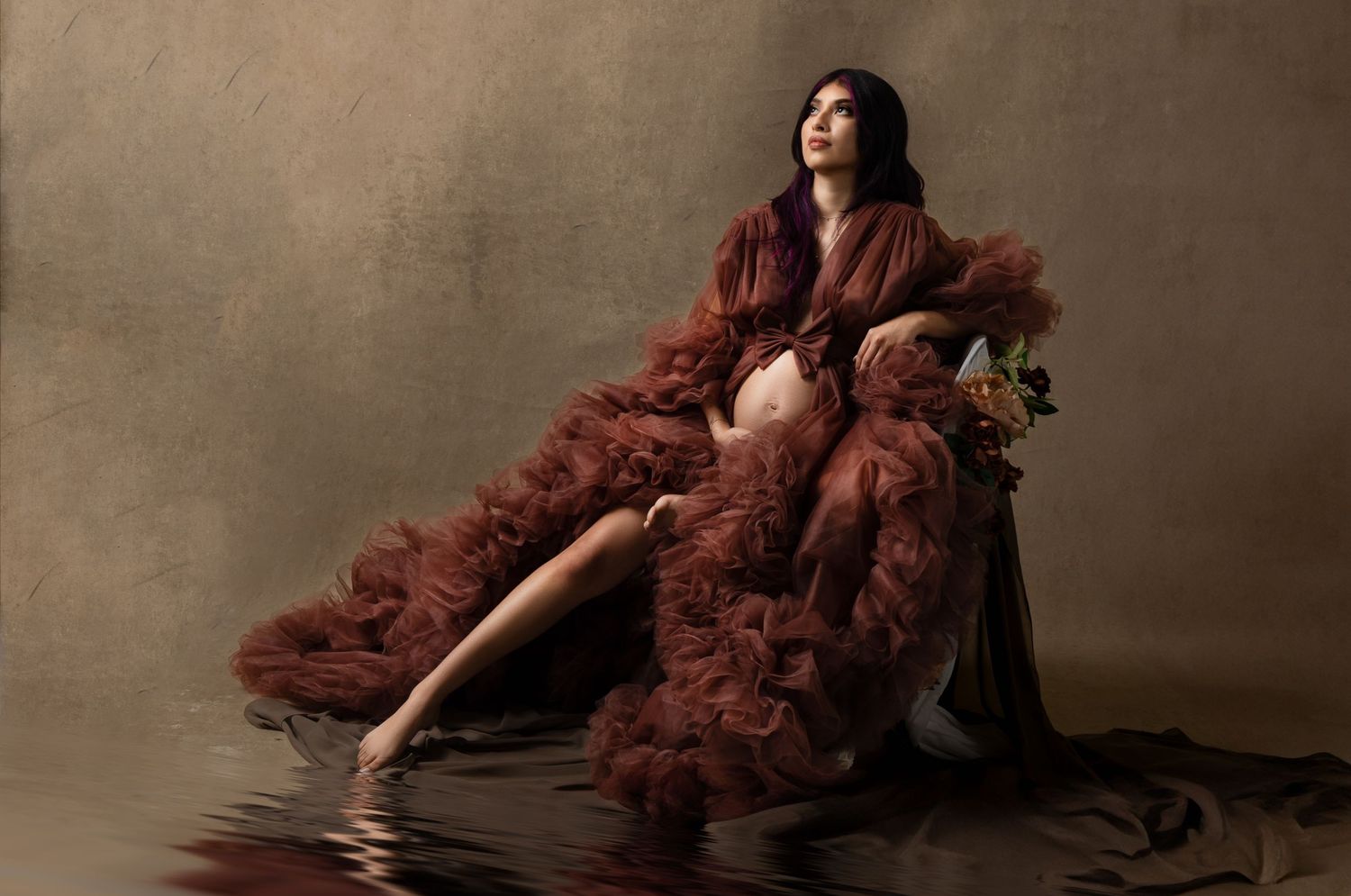 Dramatic portrait series featuring flowing burgundy fabric against a dark moody background.