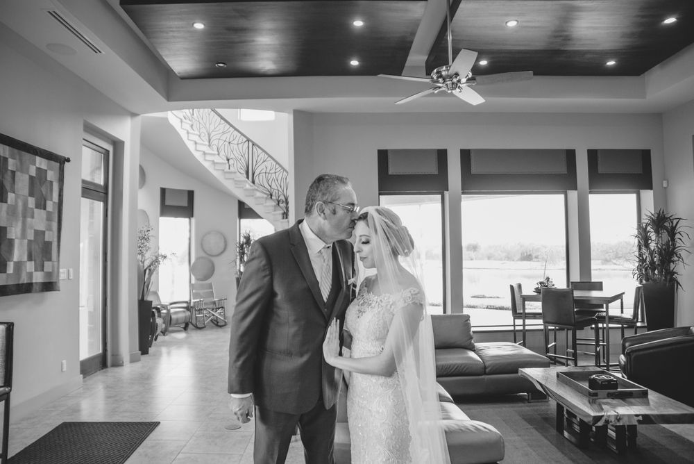 father kissing bride. getting ready. black and white. bride's accesories. getting ready. Rancho Guadalupe. Edinburg, TX