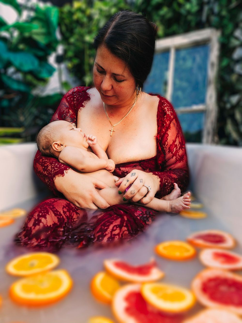 A nurturing moment with citrus fruits arranged decoratively on a table during a milk bath photoshoot.