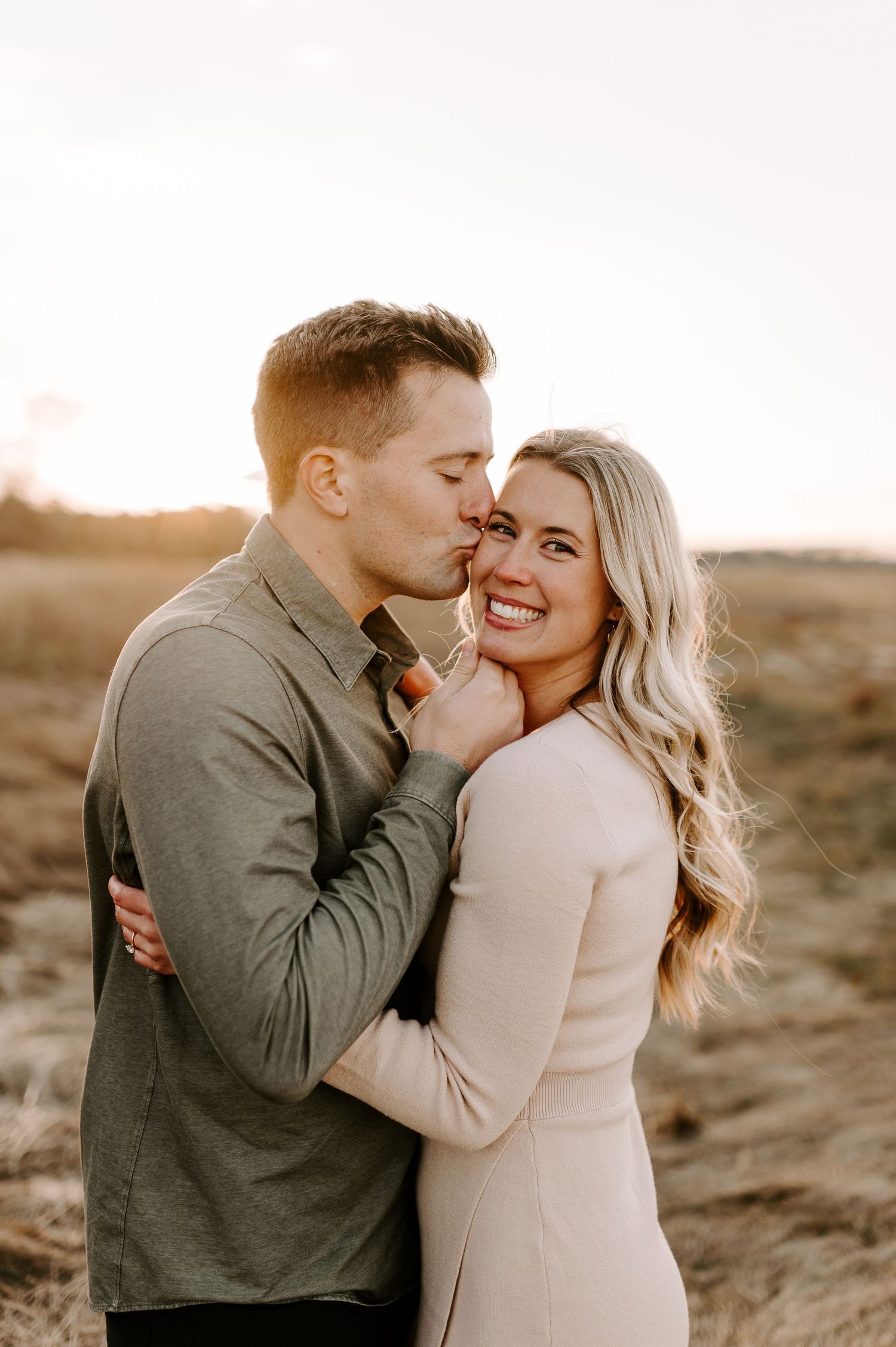 A couple shares laughter and tender moments in warm evening light.