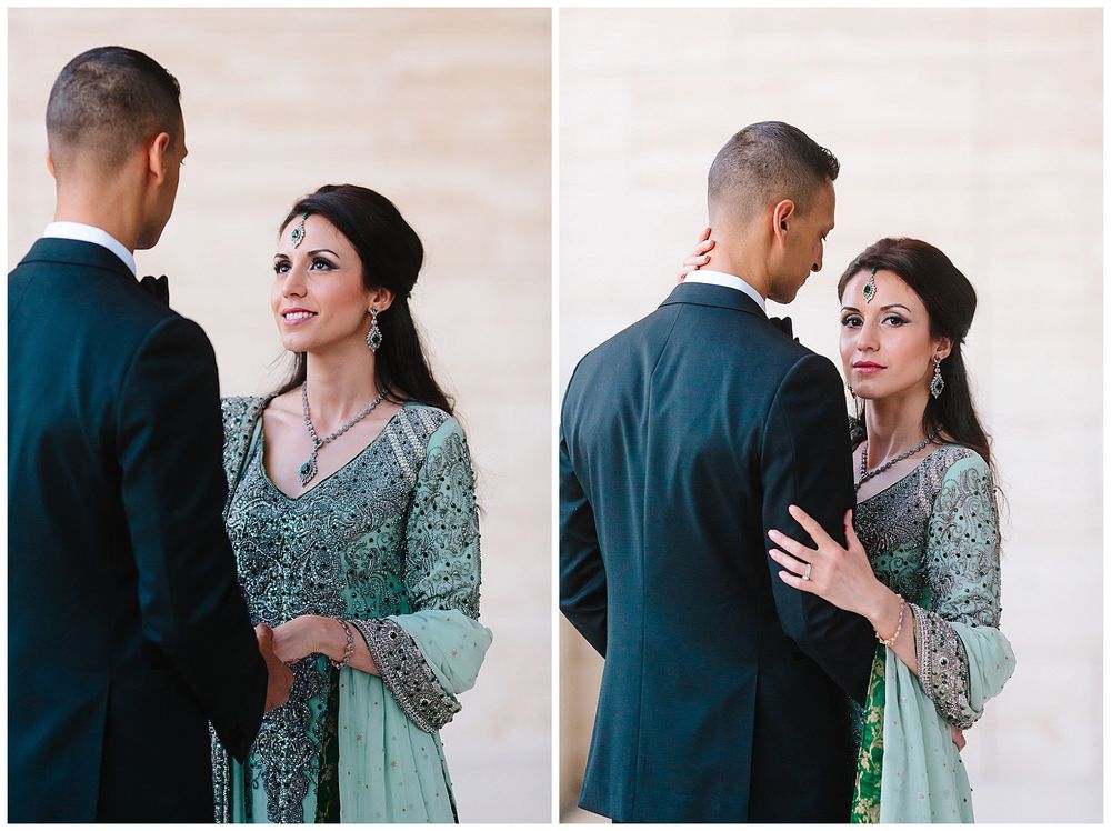 A couple shares candid moments in formal attire against a neutral wall.