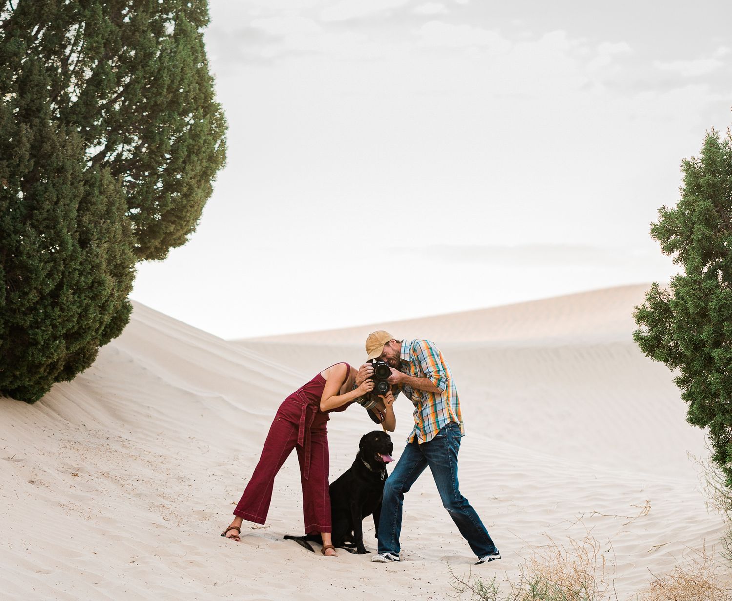 Victoria and Joe and Coltrane on a sand dune