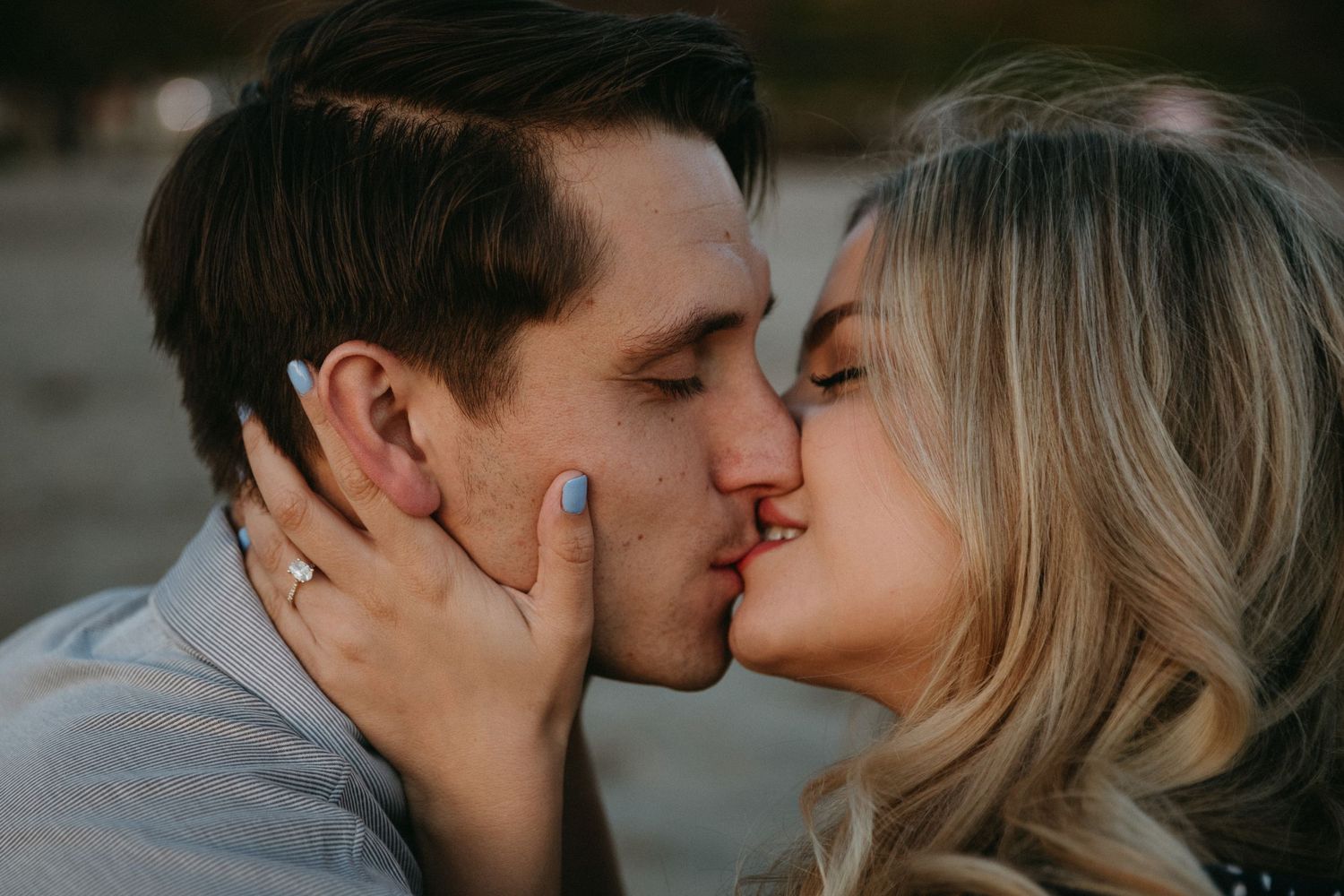 Intimate close-up of a romantic moment between a couple during an outdoor photoshoot.