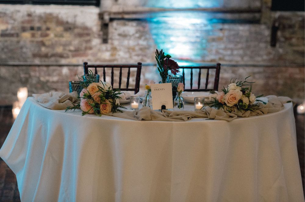 Sweetheart table for bride and groom with flowers