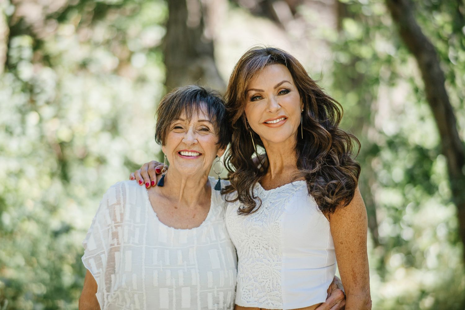 A warm outdoor portrait showcasing loving family bonds in dappled sunlight.