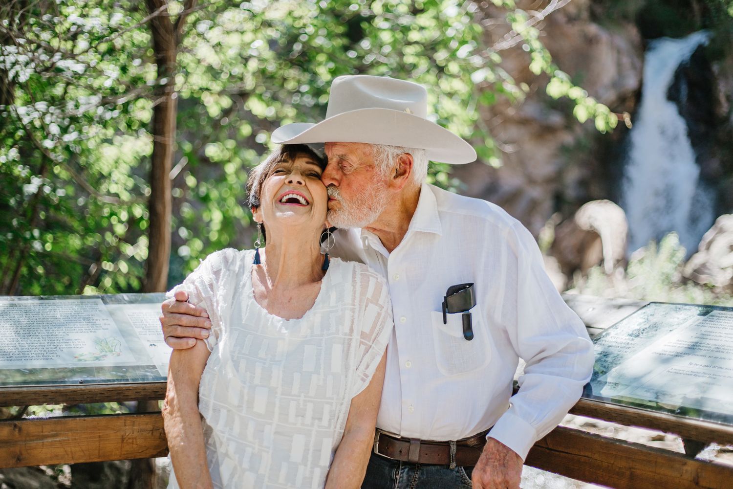 A heartwarming moment of laughter shared between family members in a natural setting.