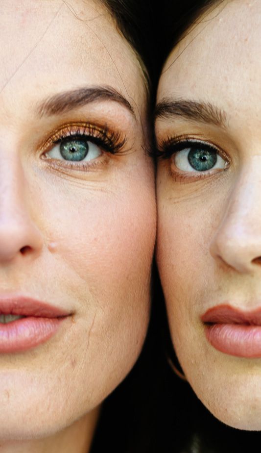 Two striking blue eyes in close-up showing similar features and makeup.