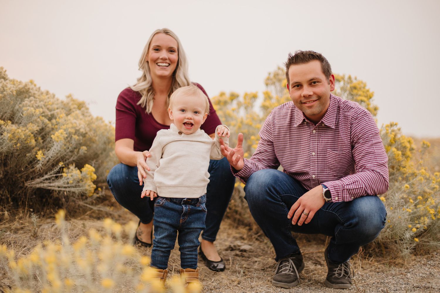 Family members sit together outdoors during autumn portrait session.