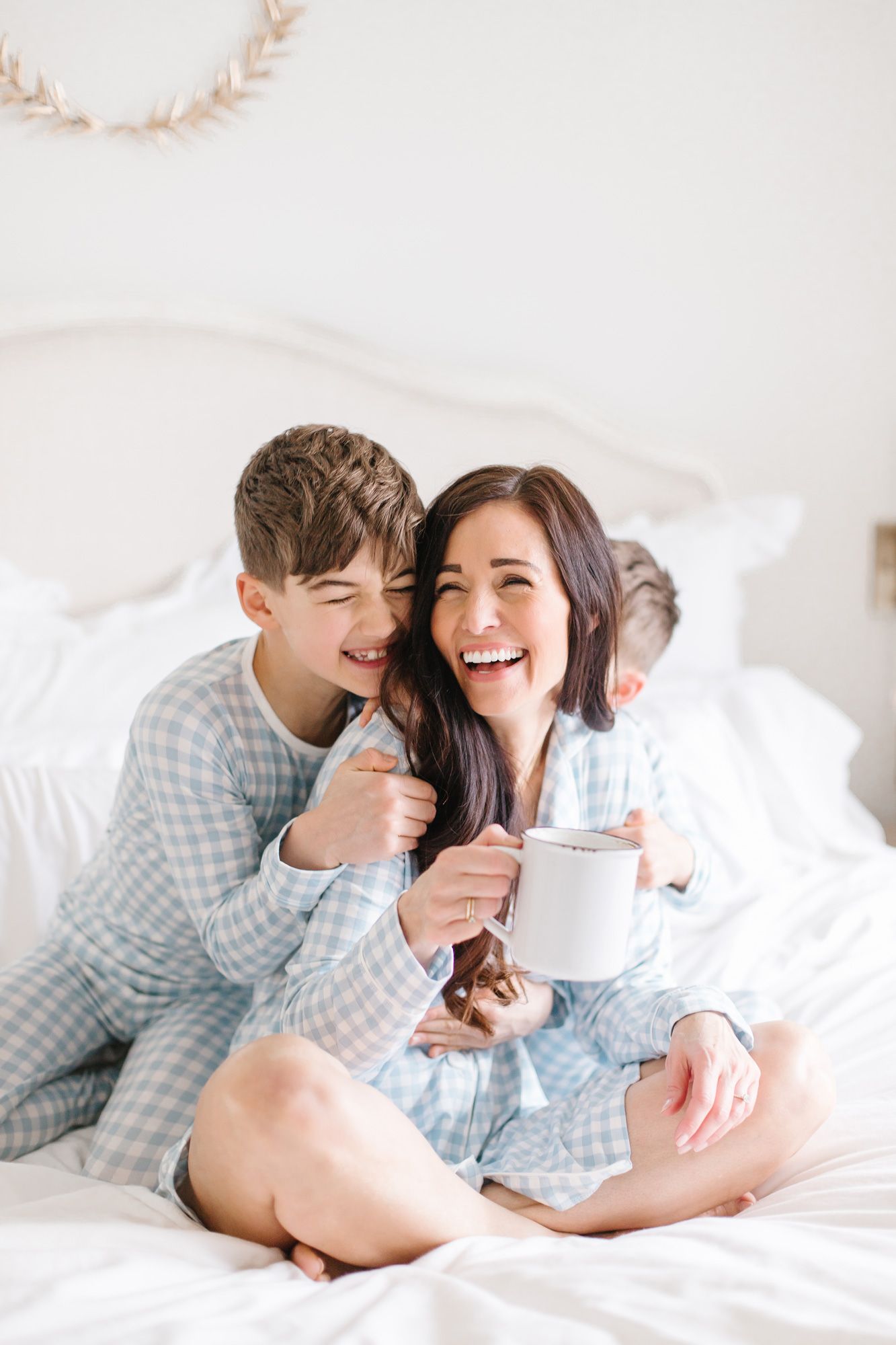 A cozy morning scene with matching pajamas as they share laughter in bed.