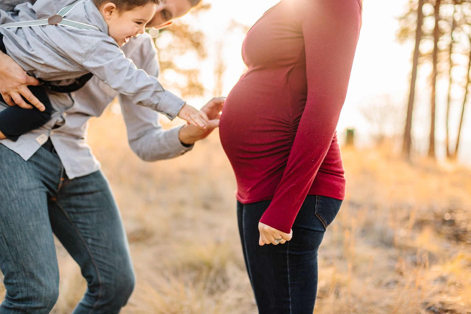 A candid outdoor family photoshoot in casual wear during golden hour.