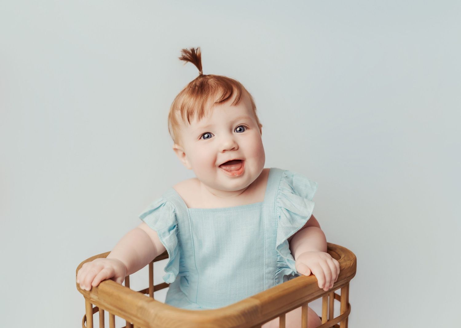cute baby girl in blue sitting in crate at her photography session in tulsa, ok