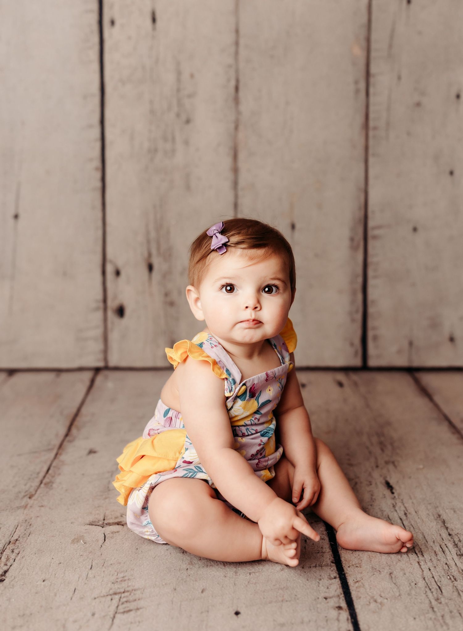 baby girl sitting at her sitter photography session in tulsa