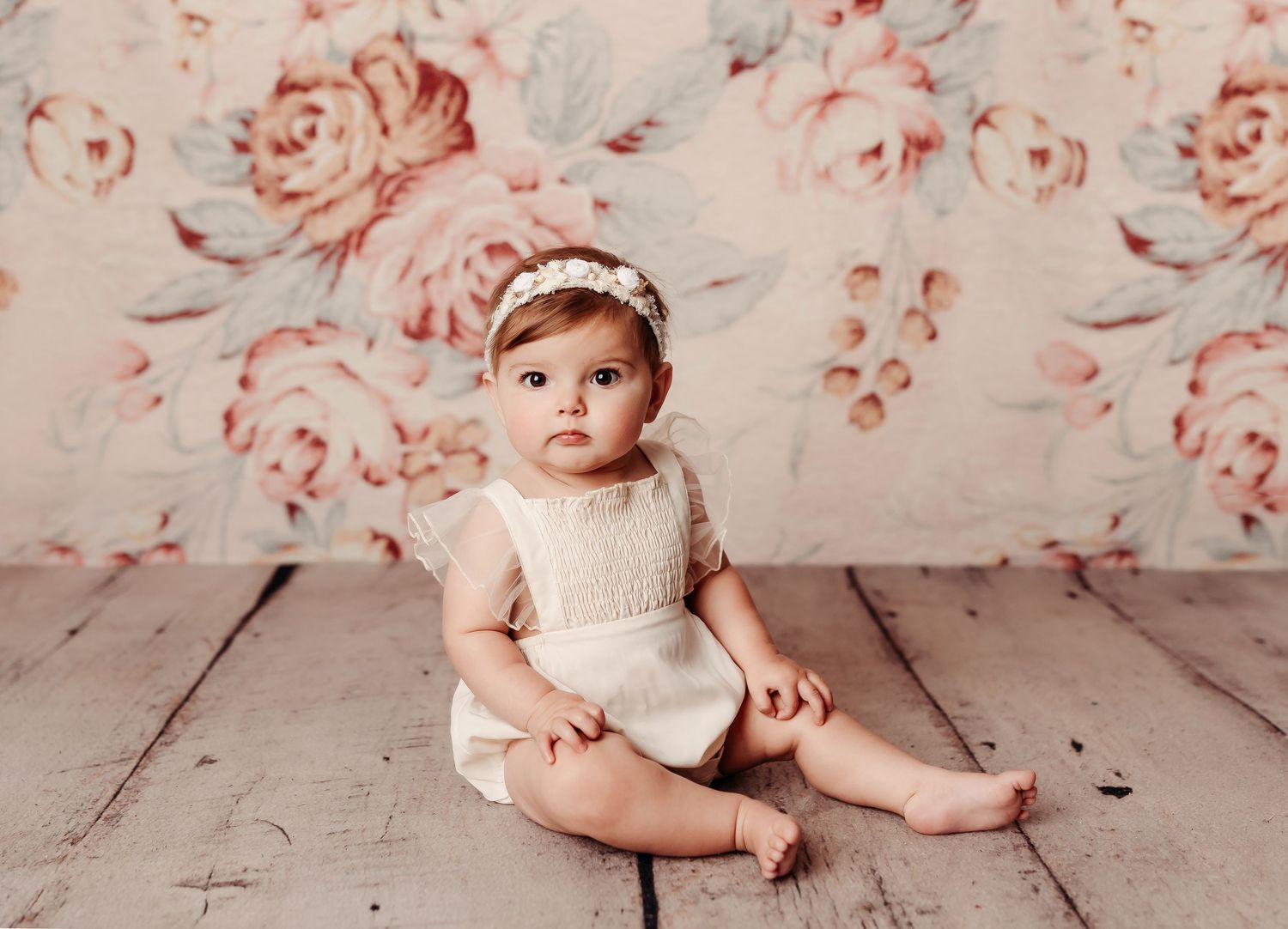 baby girl milestone session with floral background and cream romper. Her session was done in tulsa ok