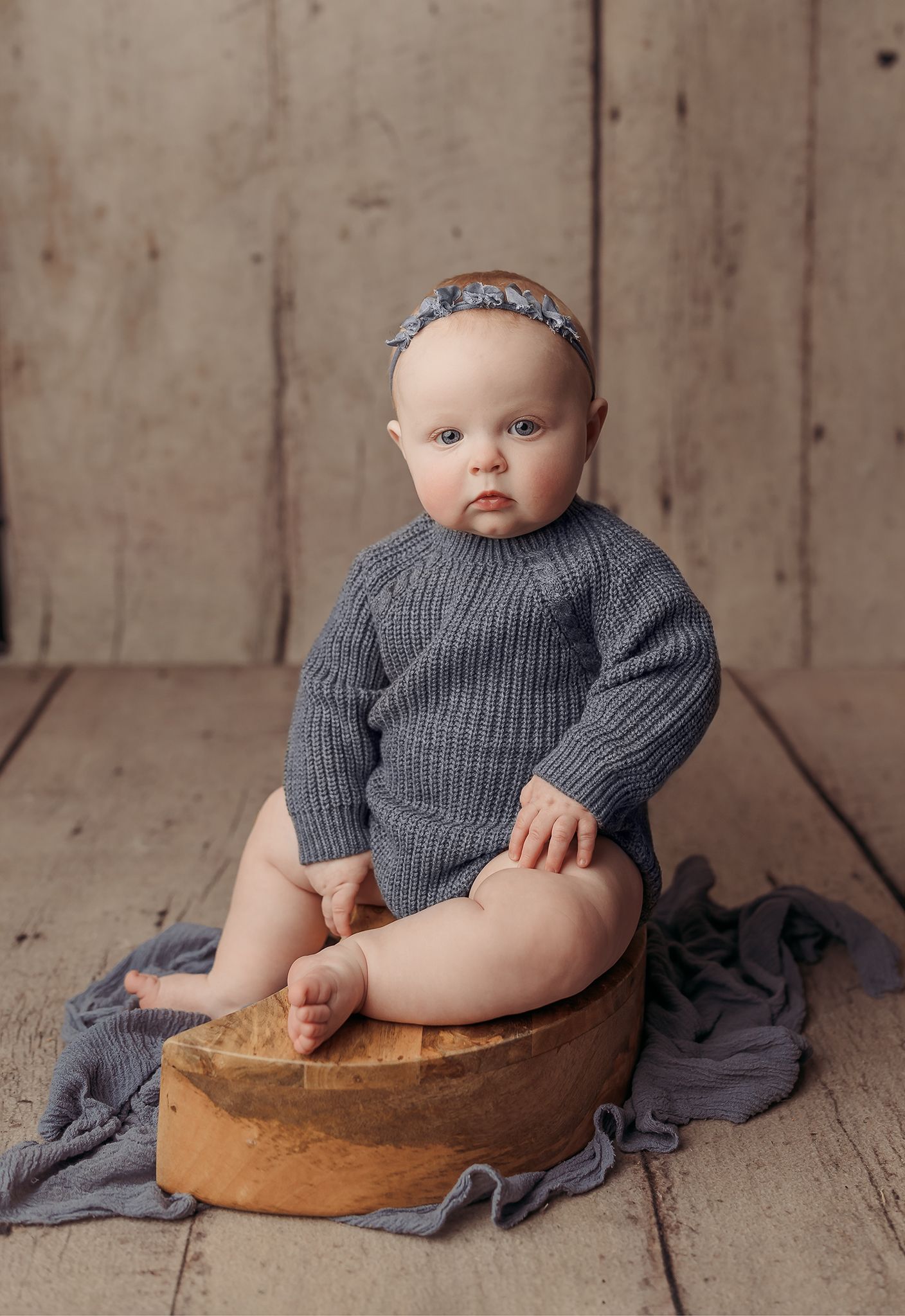 baby girl sitting on moon prop at her sitter session in Tulsa,OK