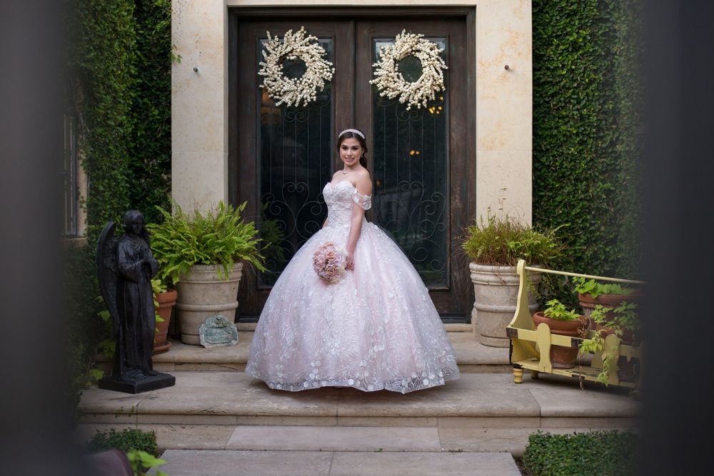 girl with quinceanera dress in front of door. Casa Polonia. Weslaco, Texas. Wedding photography