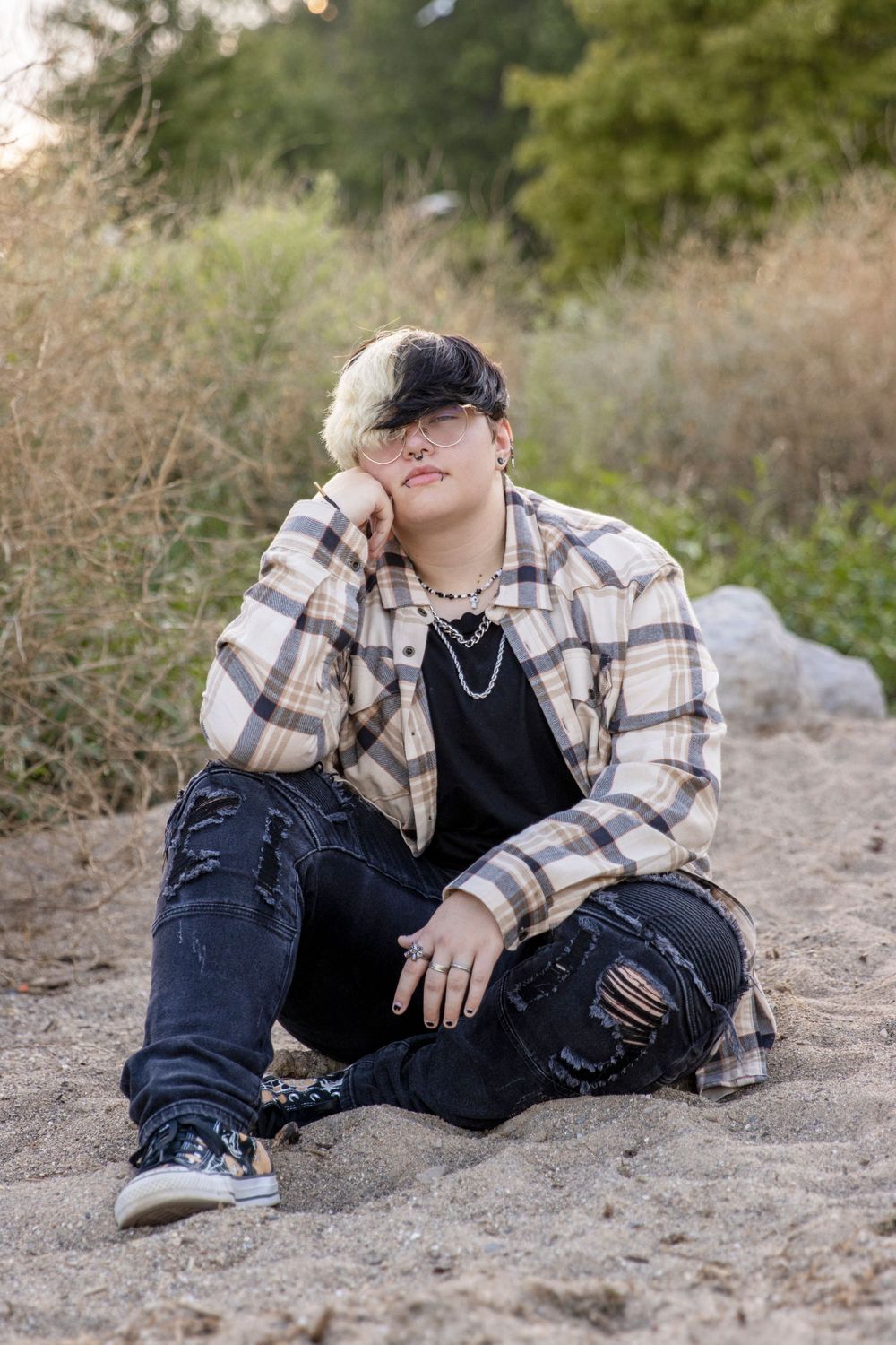 teenage sitting on the sand at a metropark in Harrison township