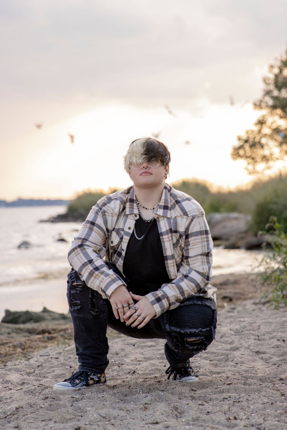 teenager posing for a photo on the beach of lake st clair