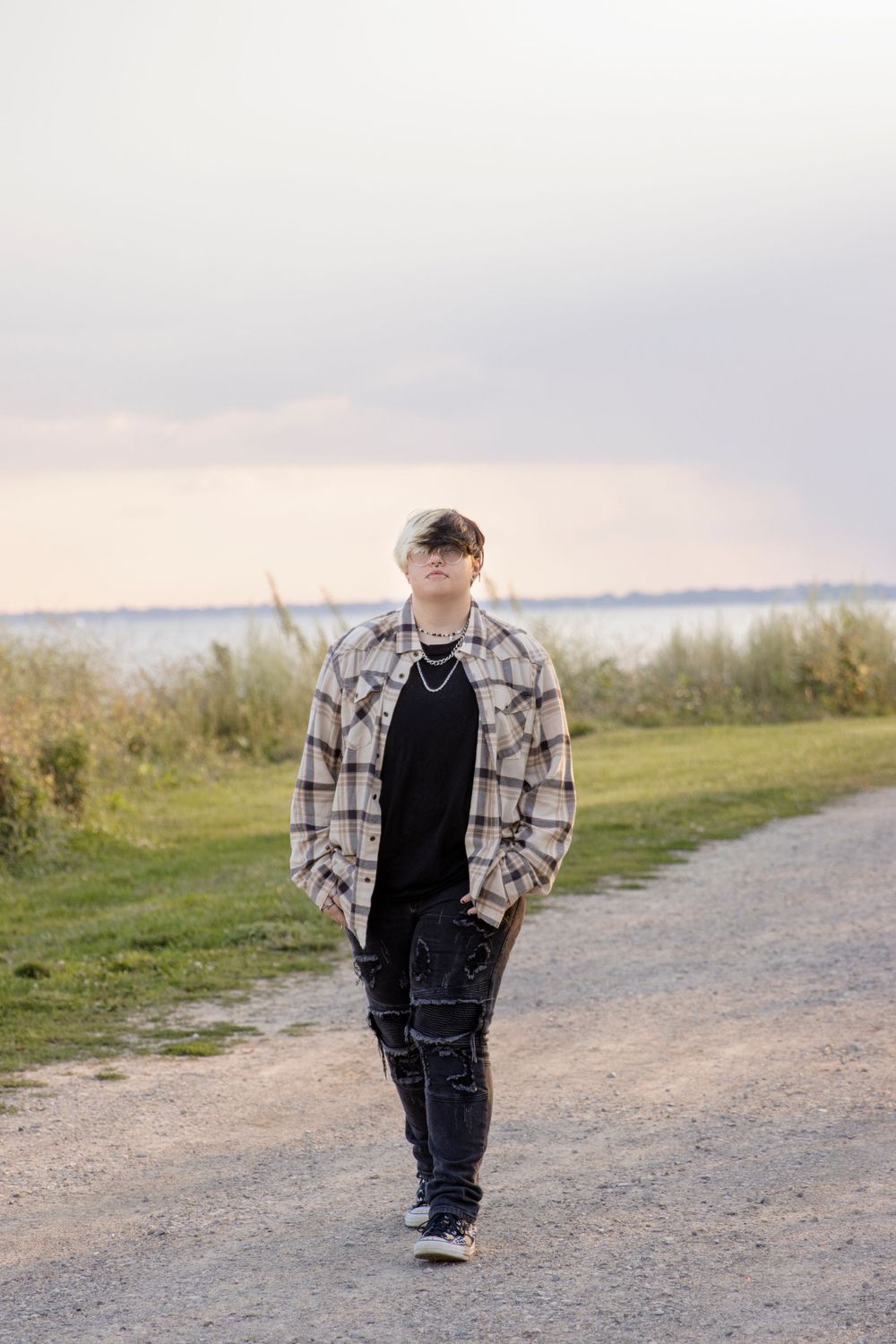 teenager walking a gravel path at lake saint claire metropark