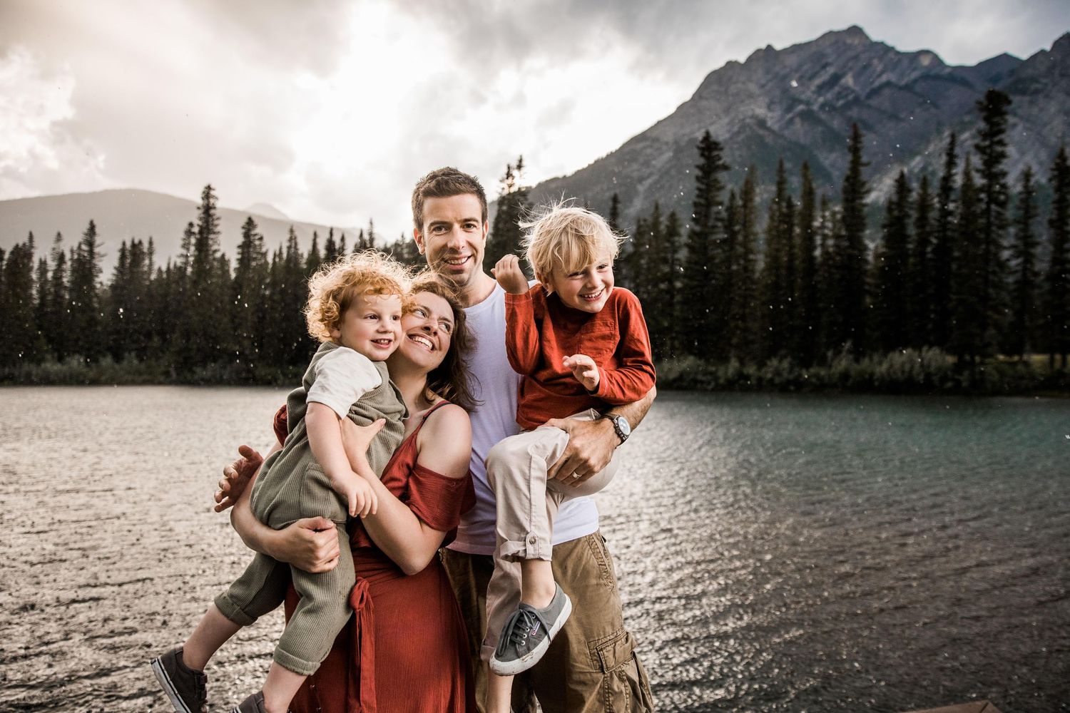 hertfordshire family photographer, family by standing by a lake with a mountain and tree backdrop