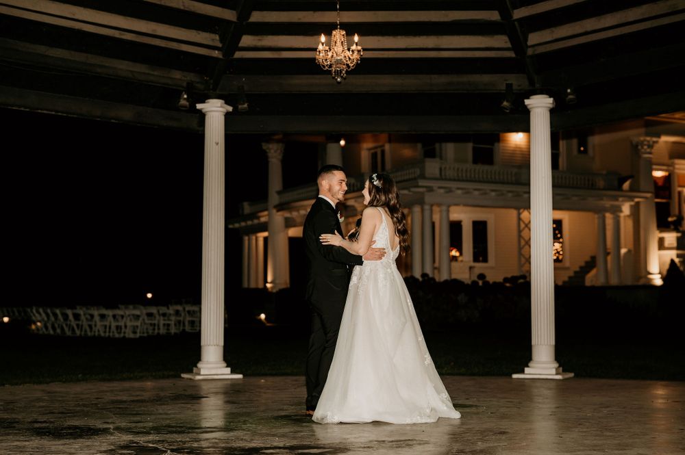 Bride and Groom dance under The Moore Mansion gazebo below the night sky.