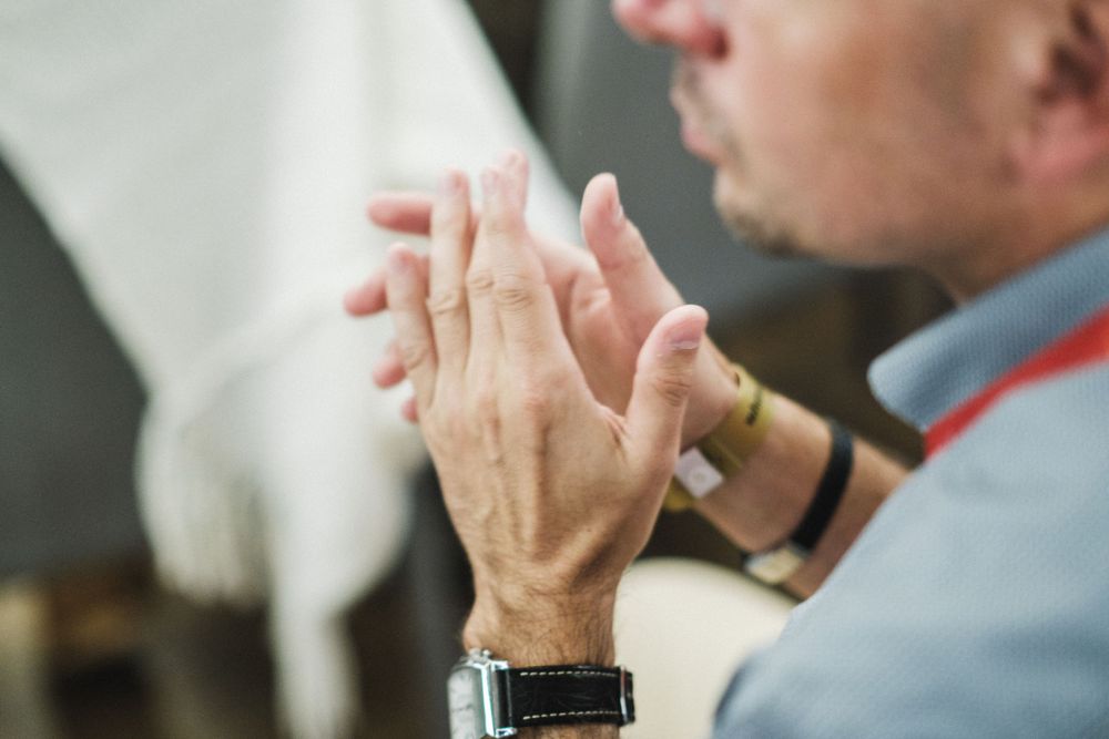Close-up of hands gesturing during a professional presentation or speech.