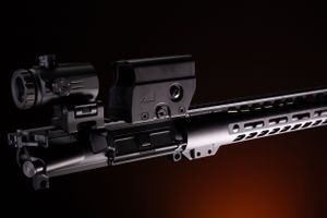 Close-up details of tactical rifle components in dramatic low-key lighting.
