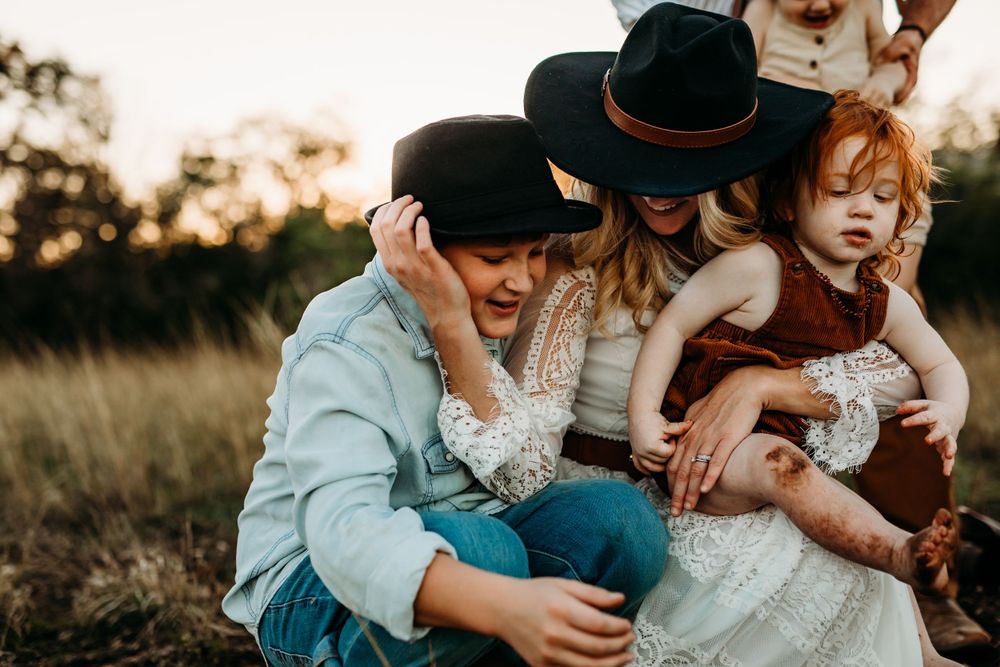 Family photographer, a mother hugs her teenage son, San Marcos family photographer