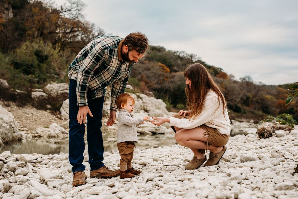 San Marcos family photographer , little boy handing mother a rock