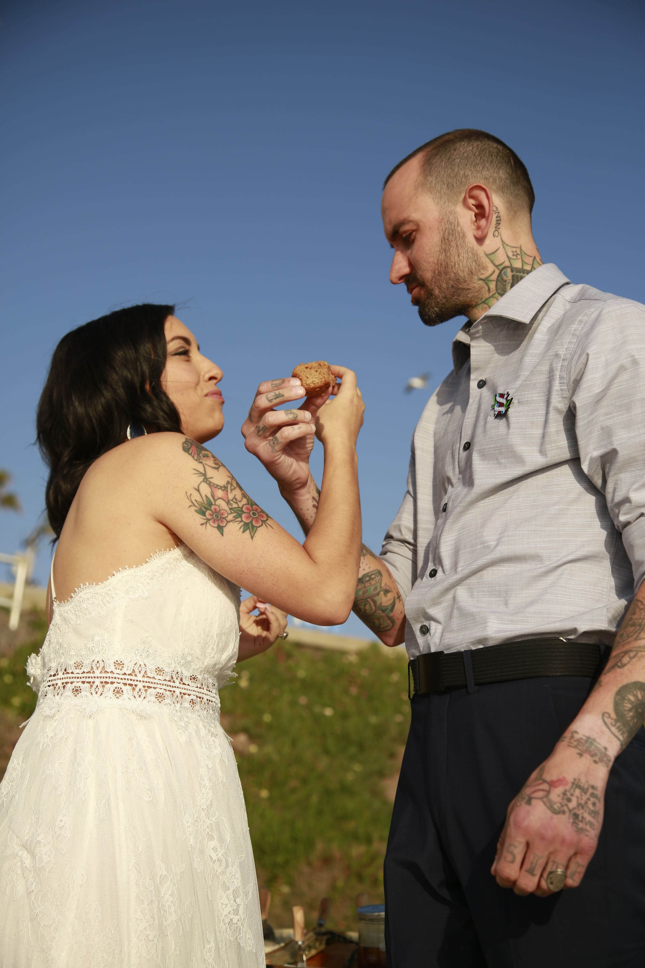 Couple shares playful moment during outdoor wedding photoshoot.