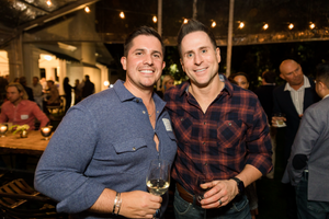 Friends enjoying drinks together at a dimly lit bar or restaurant.