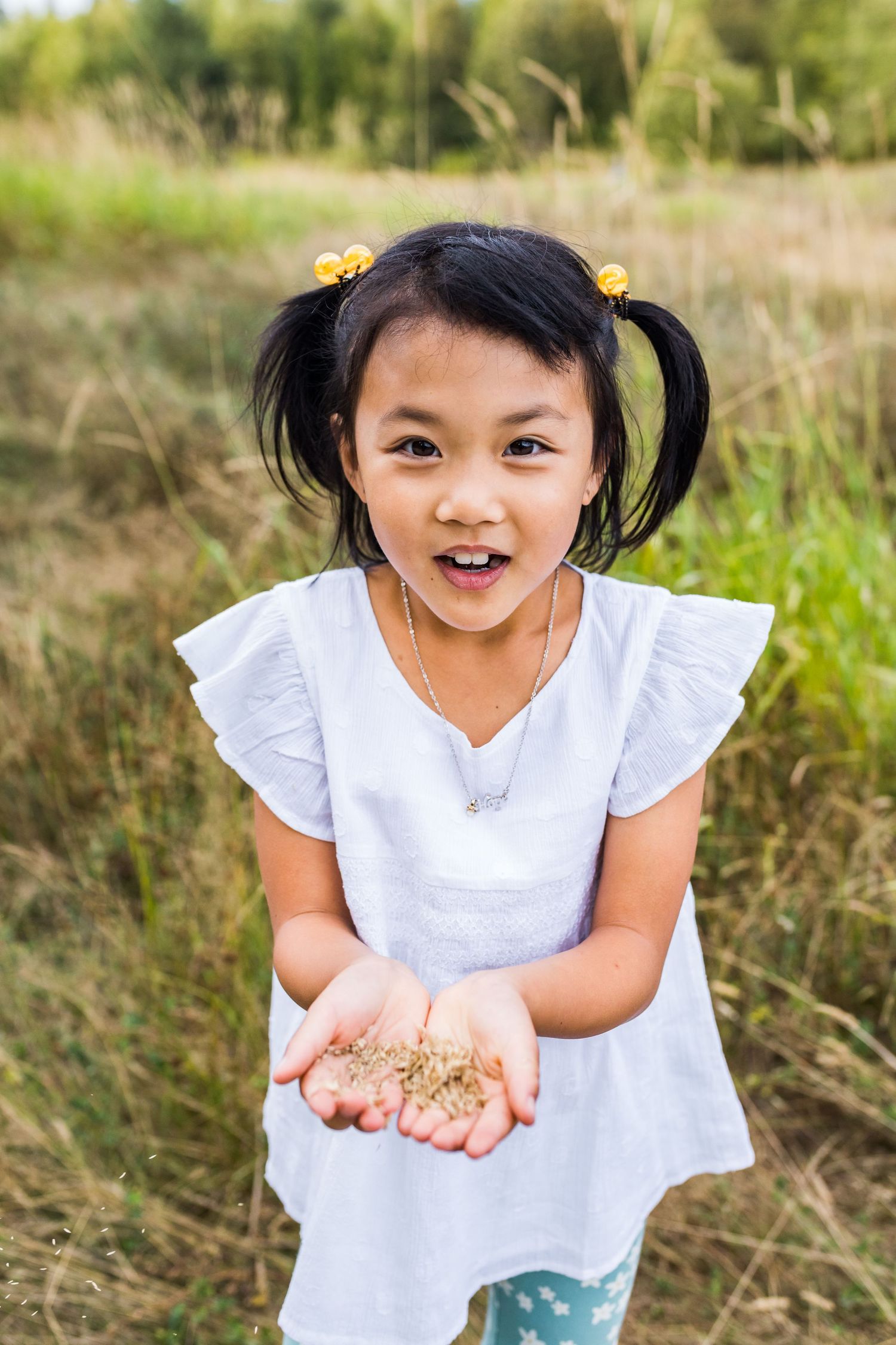 Candid moment of girl blowing wheat