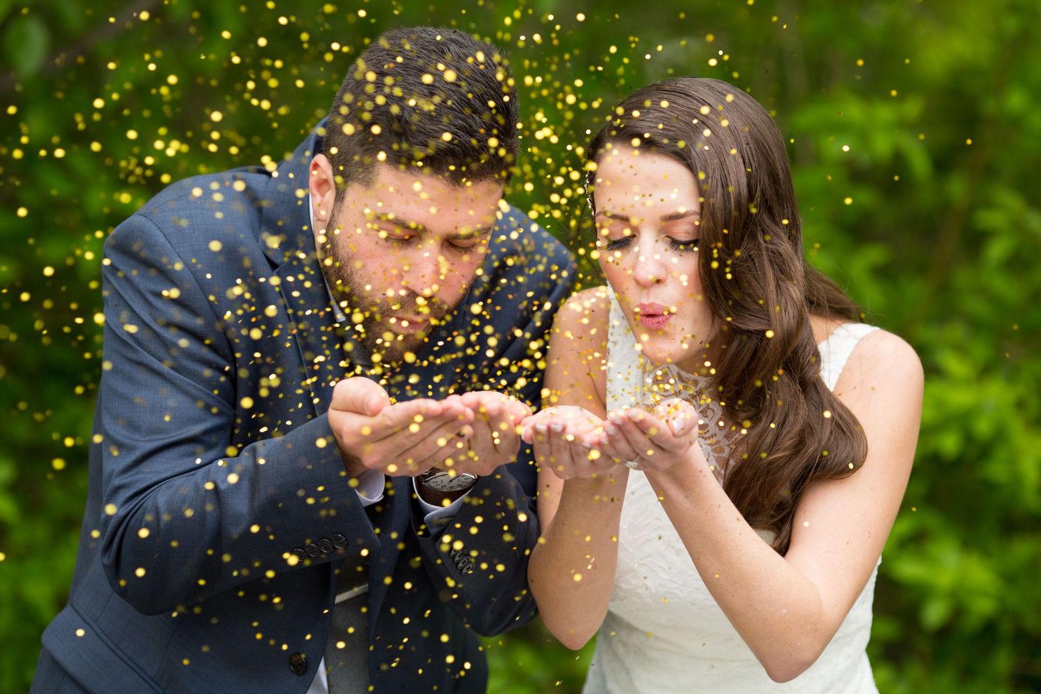Romantic moment with glitter and confetti being blown in an outdoor garden setting.