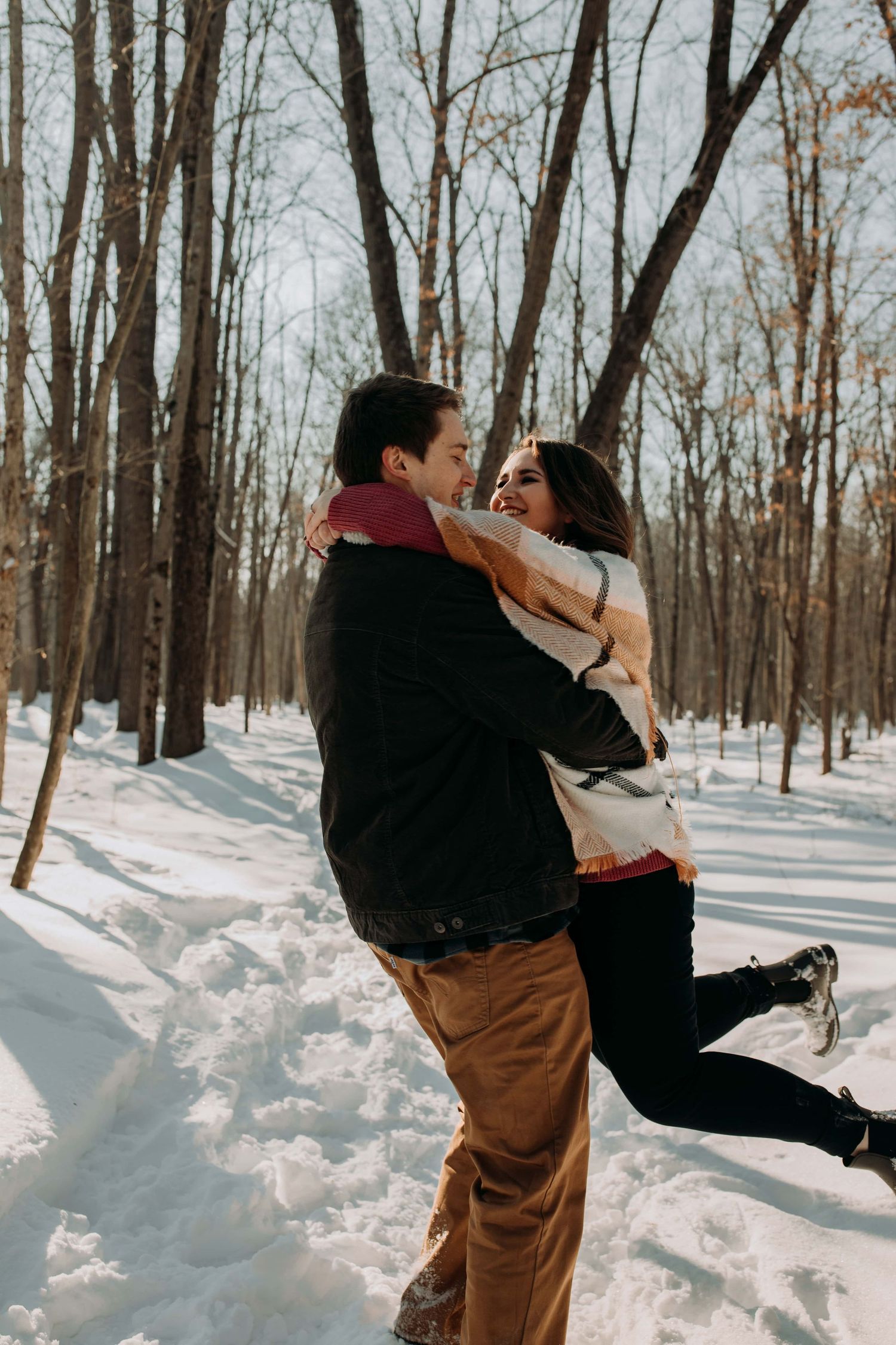 couple-tossing-eachother-around-in-snow