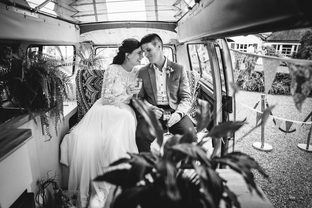 Black and white interior photo of vintage van with romantic wedding decor.