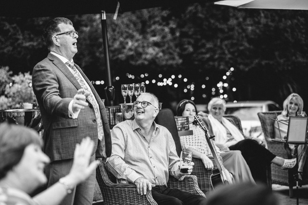 Two guests engaging in conversation at an outdoor celebration.