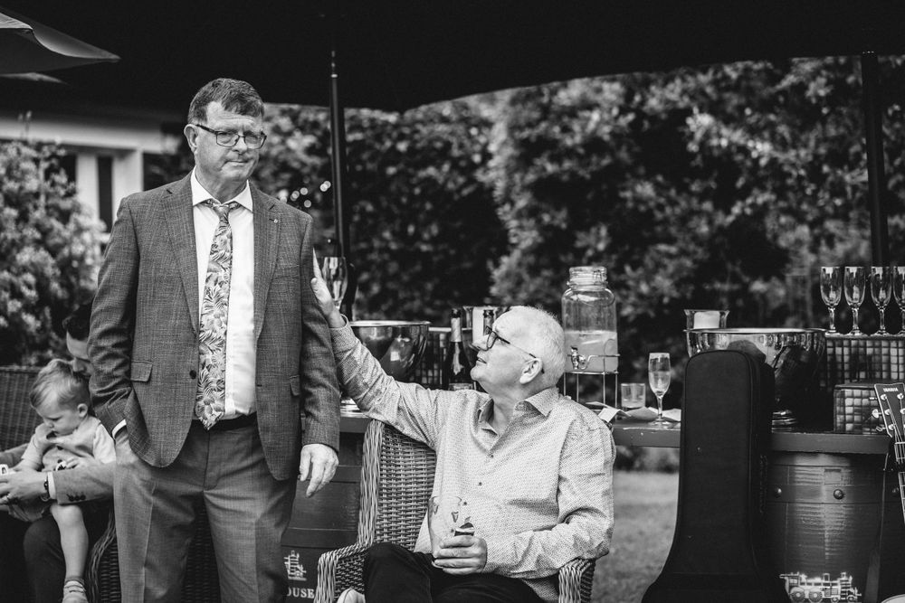 Two people sharing a moment during an outdoor reception.
