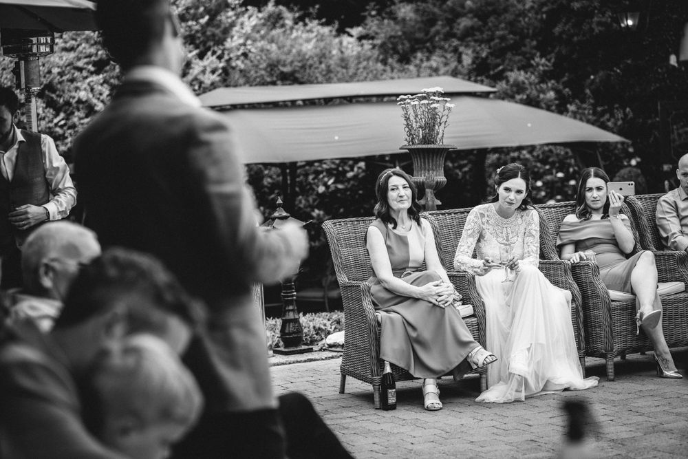 Guests watching a performance at an outdoor wedding reception.