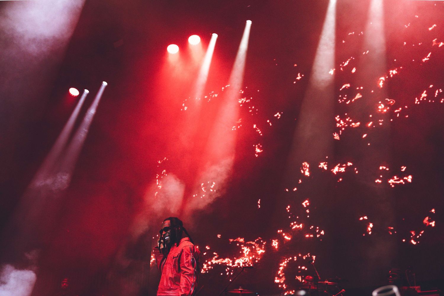 Stage performance with intense red lighting and special effects creating a dynamic atmosphere.