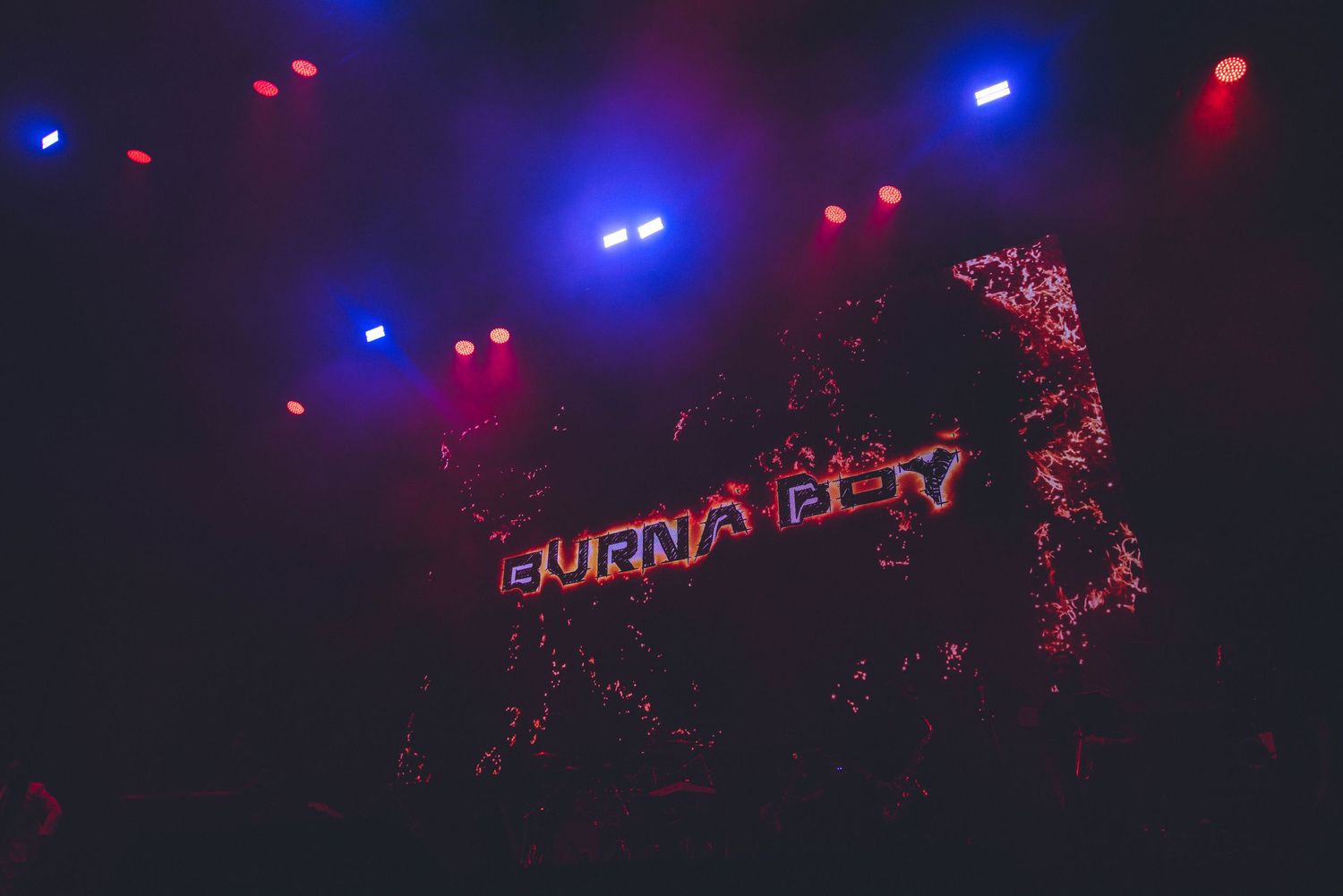 Live performance space illuminated by striking blue and red lights creating dynamic contrast.