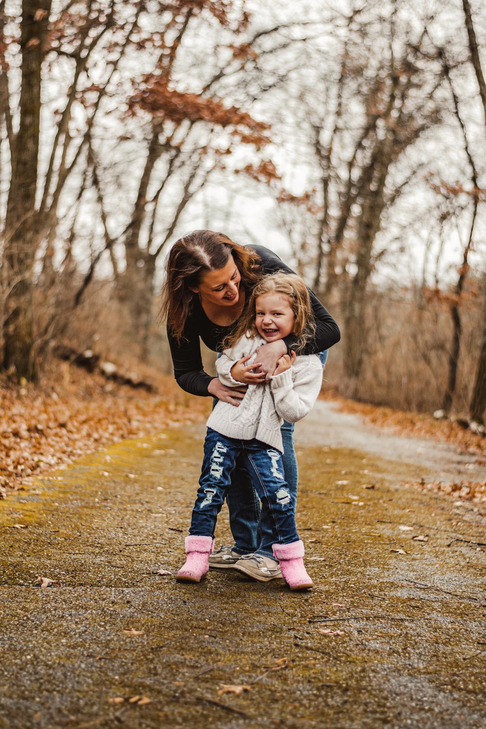 A touching autumn moment captured on a forest path with warm fall colors in the background.